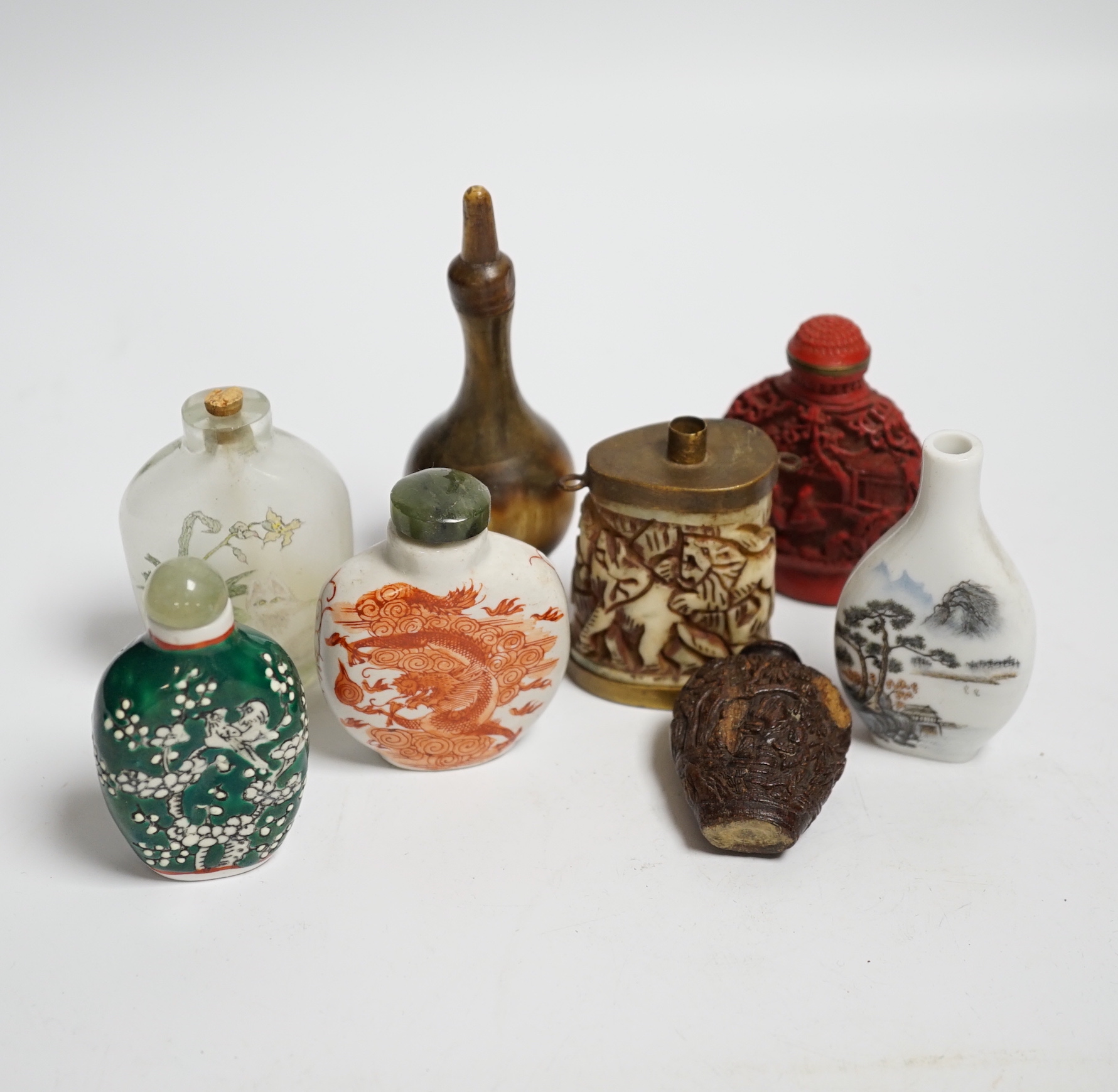 Seven various Chinese snuff bottles including horn, simulated lacquer, porcelain, glass, wood and a small bone powder flask